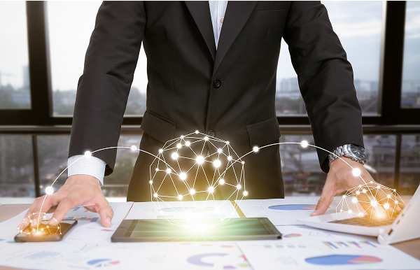 businessman-analyzing-graphs-with-technologic-devices
